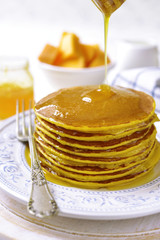 Pumpkin pancakes with honey for a breakfast.