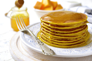 Pumpkin pancakes with honey for a breakfast.