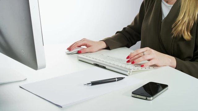 Woman Using Mouse and Typing on a Keyboard