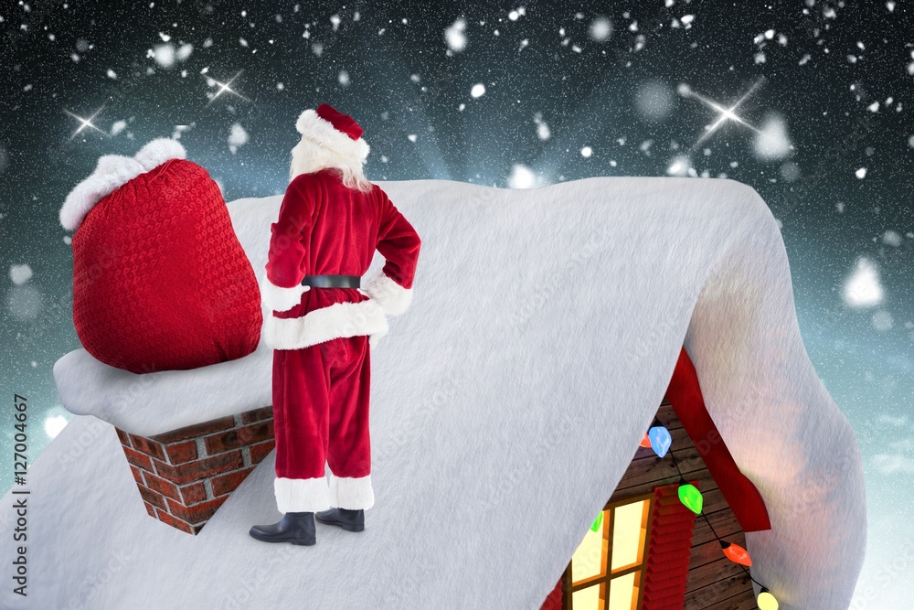 Poster Santa claus standing on the roof top with his gift sack