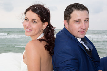 Bride and groom on the beach in wedding dress