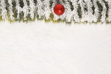 single red ornament and pine background