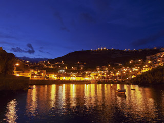 Fototapeta na wymiar Portugal, Madeira, Twilight view of the fishermen port in the Camara de Lobos.