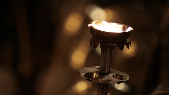 CU Bronze Torch Burning At Night / Varanasi, India