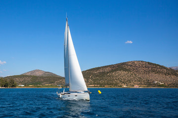 Fototapeta na wymiar Yacht boat finished at sailing regatta on the sea.