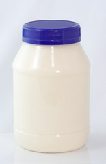 Plastic jar of mayonnaise. No Label. Vertical.