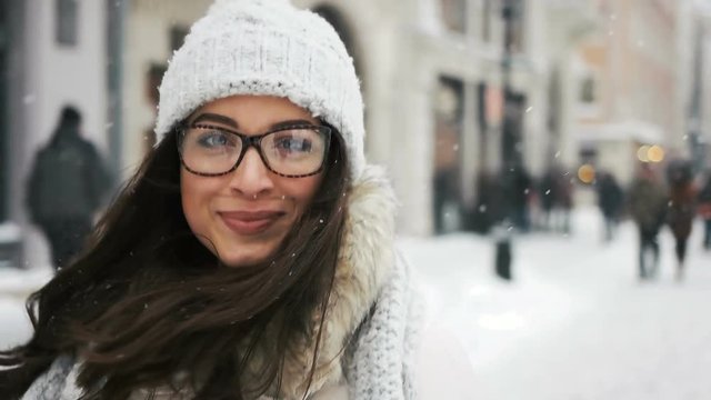 happiness, winter holidays, christmas, beverages and people concept - Attractive beautiful lady posing and flirting on camera over snowy city background