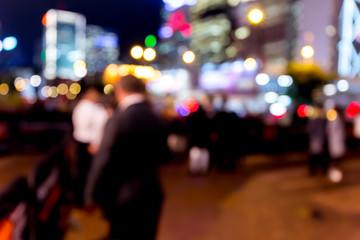 Abstract bokeh background of people at night