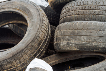 Mound of used car tires in a junkyard