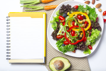 fresh vegetable salad with notebook paper