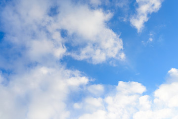 Bright blue sky & puffy clouds as background
