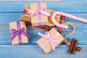 Wooden sled and wrapped gifts with ribbons for Christmas or other celebration