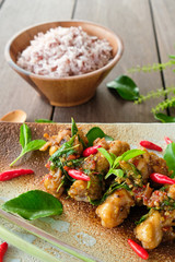 Stir-fried chicken with basil and rice on wood table