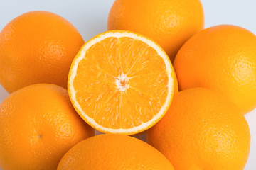 Fresh orange and cut in half on white background