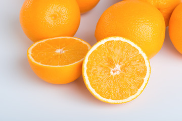 Fresh orange and cut in half on white background