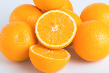 Fresh orange and cut in half on white background