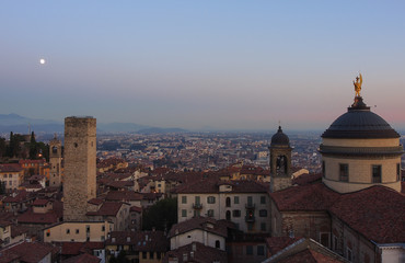 Fototapeta na wymiar Bergamo - Old city (Citta Alta). One of the beautiful city in Italy. Lombardia. Evening sunset. Landscape on the old city, Cathedral, clock towers and the Po Valley.