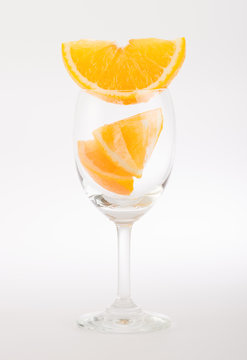 Fresh orange in glass on white background