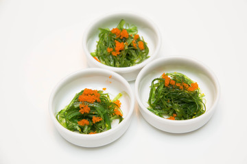  portion of fresh wakame seaweed on a white background