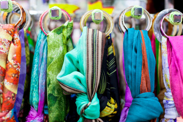Close up of women's scarves hanging in a store