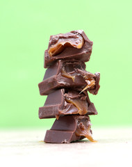 Chocolate blocks stack on green background