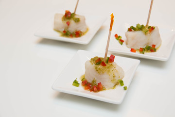  fish cocktail  with sauce in a white dish