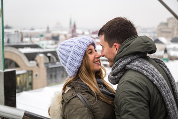 Fototapeta premium Young couple in love walking in the city, holding hands