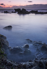 beach with rocks at sunset