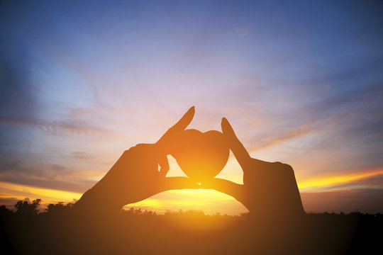 Stock Photo:.hands holding hearts silhouette