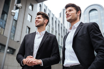 Two businessmen standing near business center