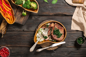 Sliced grilled steak with garnish of rice in wooden plate