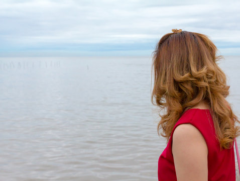 woman red shirt look at sea view feeling sad