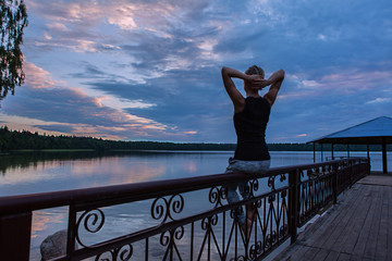 Fototapeta premium young woman enjoy morning sunrise on the lake. Sunset.