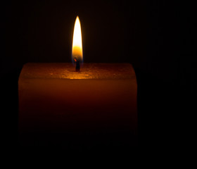 Candle on dark background