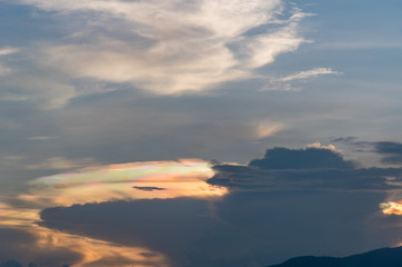 Iridescent pileus cloud at during sunset, rainbow clouds backgro