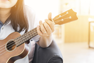 woman handicraft playing ukulele