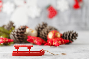 Holiday decoration with Christmas lights and cones over wooden b