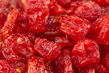 Dried cherries close up background. Heap of glossy red cherry. Top view.
