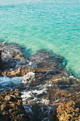 Fototapeta na wymiar Natural rocks and turquoise clear sea waters at Kleopatra beach, Alanya, Turkey, Mediterranean coast