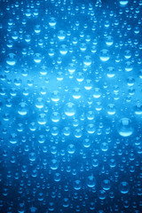 Obraz na płótnie Canvas Blue water drops of on treat water-repellent surface in macro lens shot small-DOF for screen wallpapers