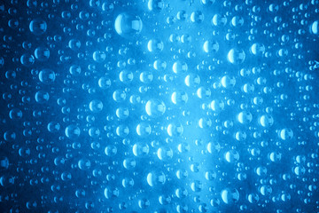 Blue water drops of on treat water-repellent surface in macro lens shot small-DOF for screen...