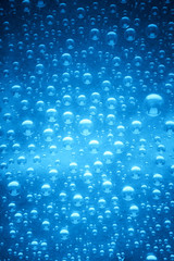 Blue water drops of on treat water-repellent surface in macro lens shot small-DOF for screen wallpapers