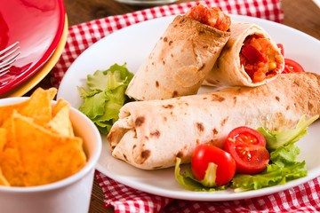 Tortilla wraps with chicken and vegetable.