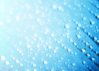 Blue water drops of on treat water-repellent surface in macro lens shot small-DOF for screen...