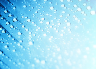Blue water drops of on treat water-repellent surface in macro lens shot small-DOF for screen...