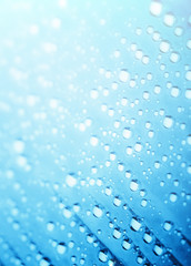 Blue water drops of on treat water-repellent surface in macro lens shot small-DOF for screen...
