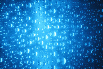 Blue water drops of on treat water-repellent surface in macro lens shot small-DOF for screen...