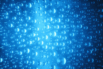 Blue water drops of on treat water-repellent surface in macro lens shot small-DOF for screen wallpapers