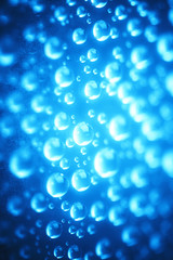 Blue water drops of on treat water-repellent surface in macro lens shot small-DOF for screen wallpapers