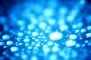 Blue water drops of on treat water-repellent surface in macro lens shot small-DOF for screen...